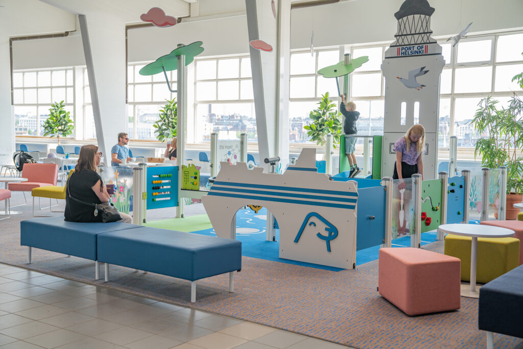 Children playing on the playground in the terminal lobby.