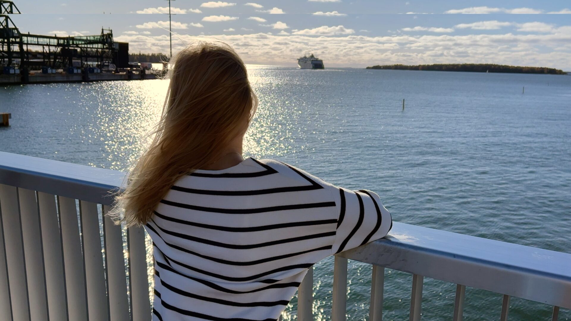 A young woman looks at sea.