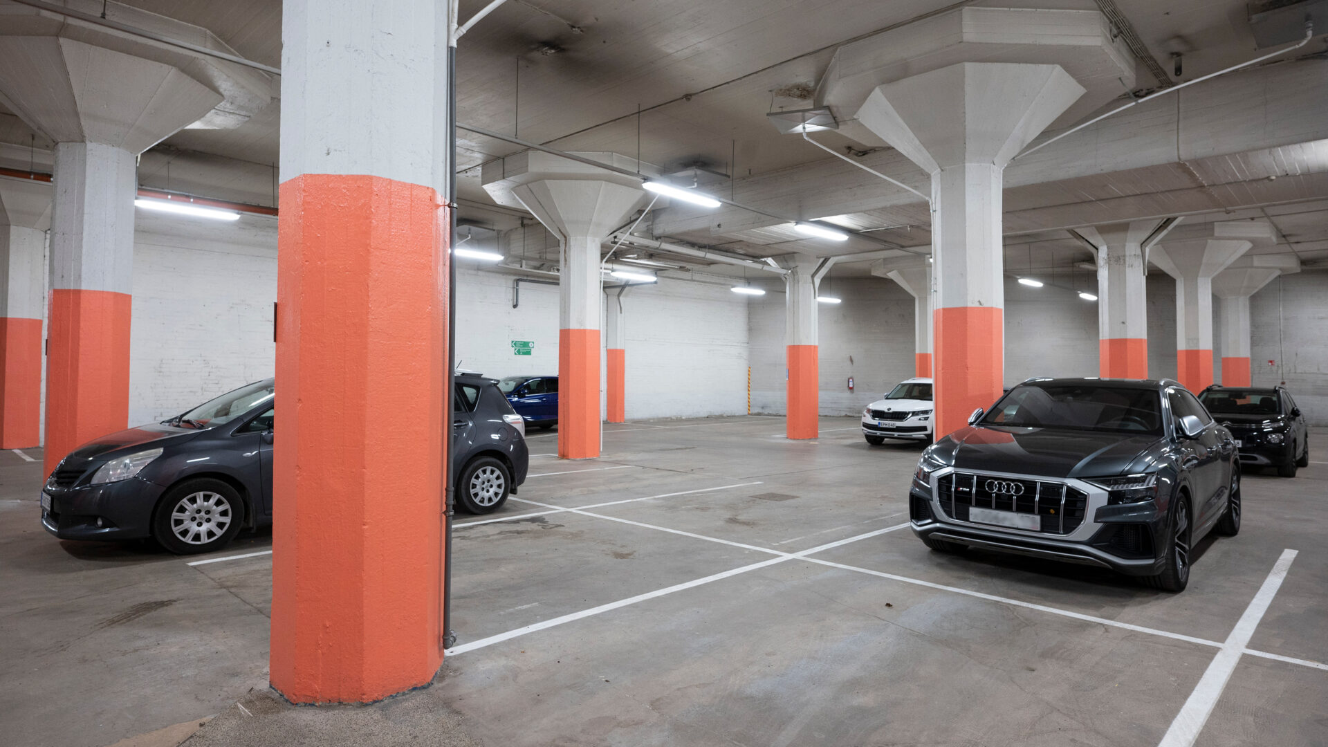 Cars parked at a park hall.